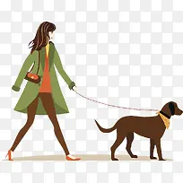 牵着狗走路的时尚女人
