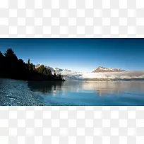 雪山树林湖水背景