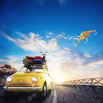 蓝天白云下公路上的黄色汽车和行李背景素材