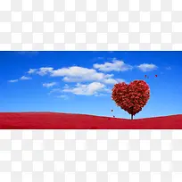 蓝天白云下的红色爱心树背景素材