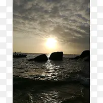 海边夕阳黑色礁石美丽背景